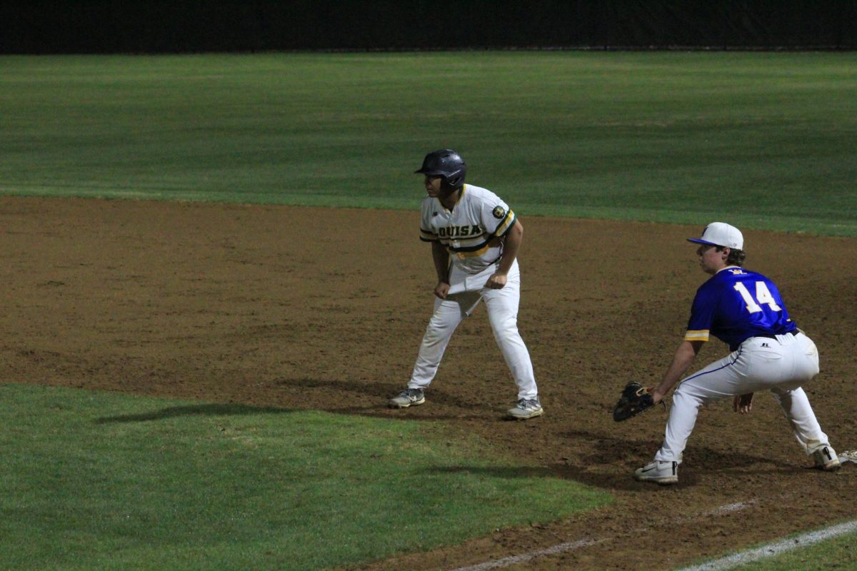 Junior Ian Taylor inching off of second base attempting to steal.