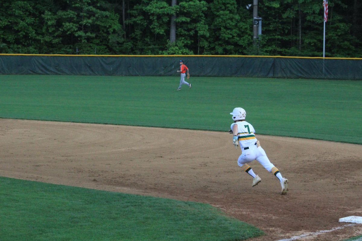 Senior Elijah Best runs from first to second base after hitting the ball. 