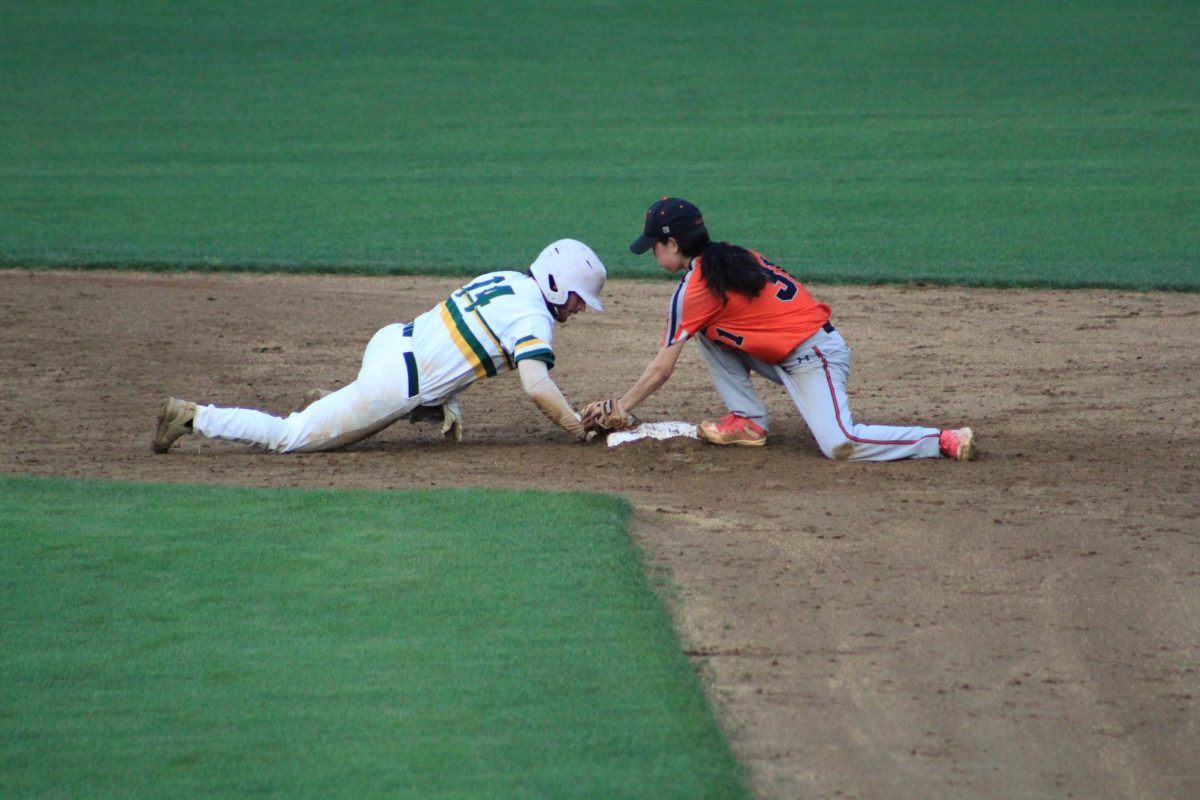 Senior DJ Harlow sliding back to second base safely without being tagged out. 