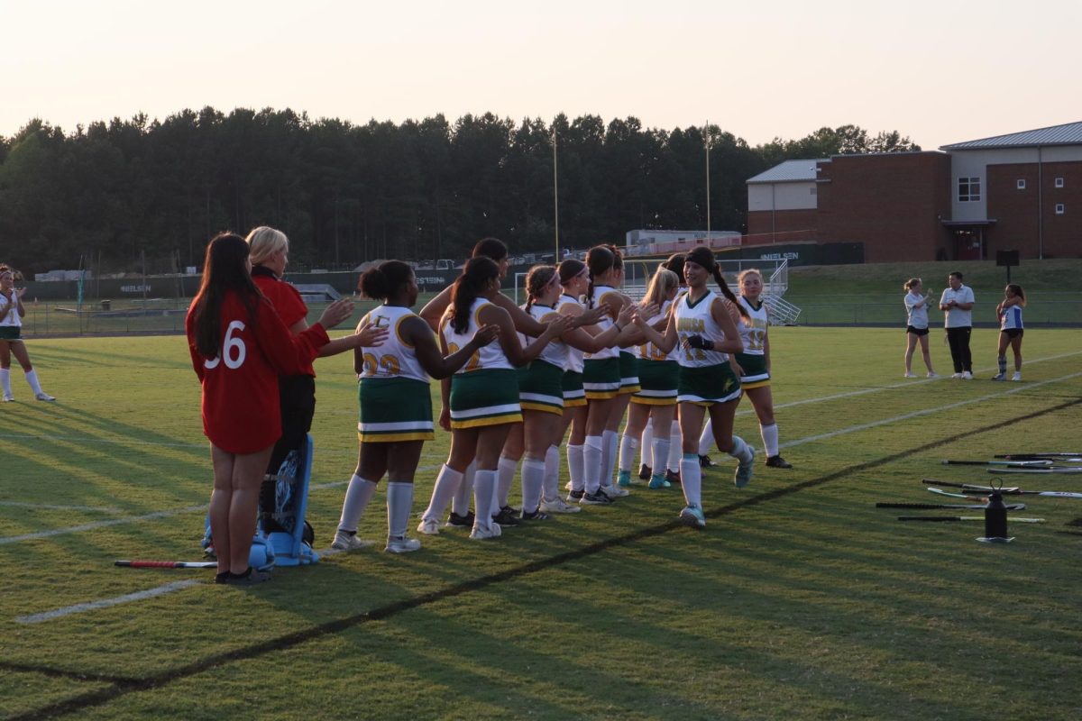 Junior Laurelei Choi high fives her teammates after having her name announced.