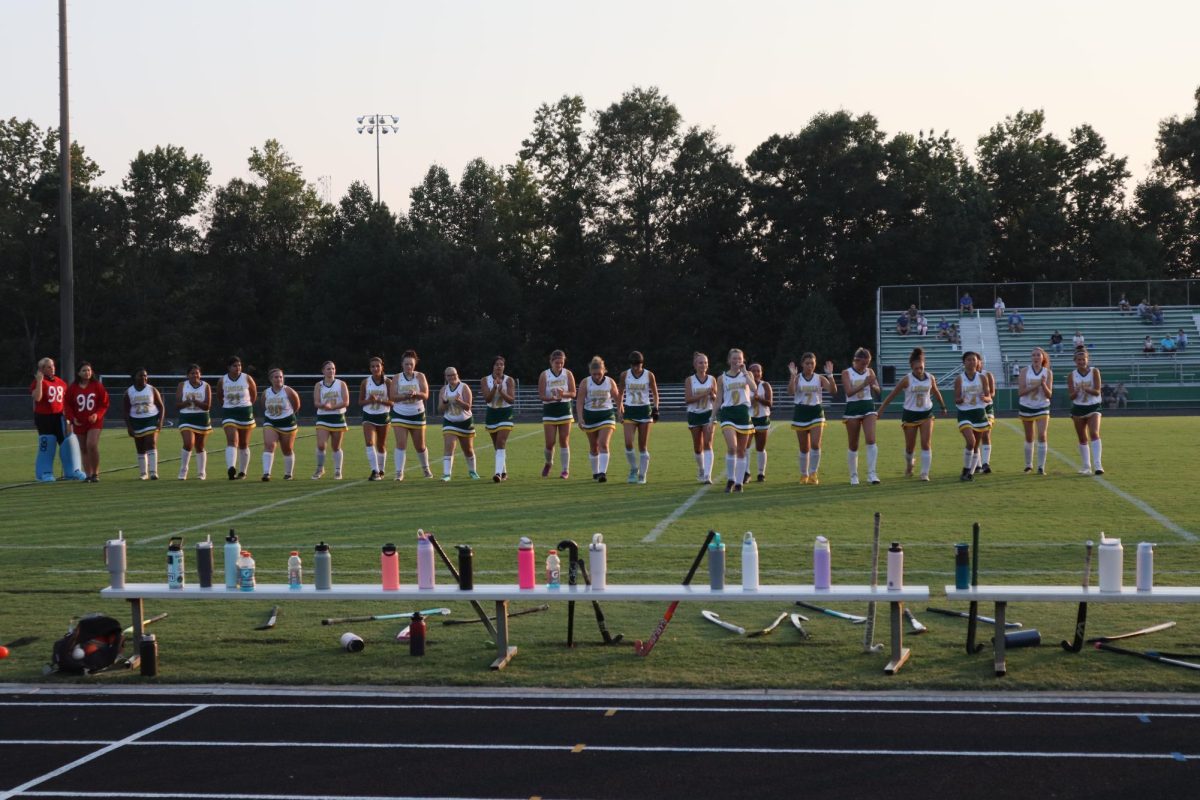 The Varsity girls field hockey team walks to the benches after having their names announced.
