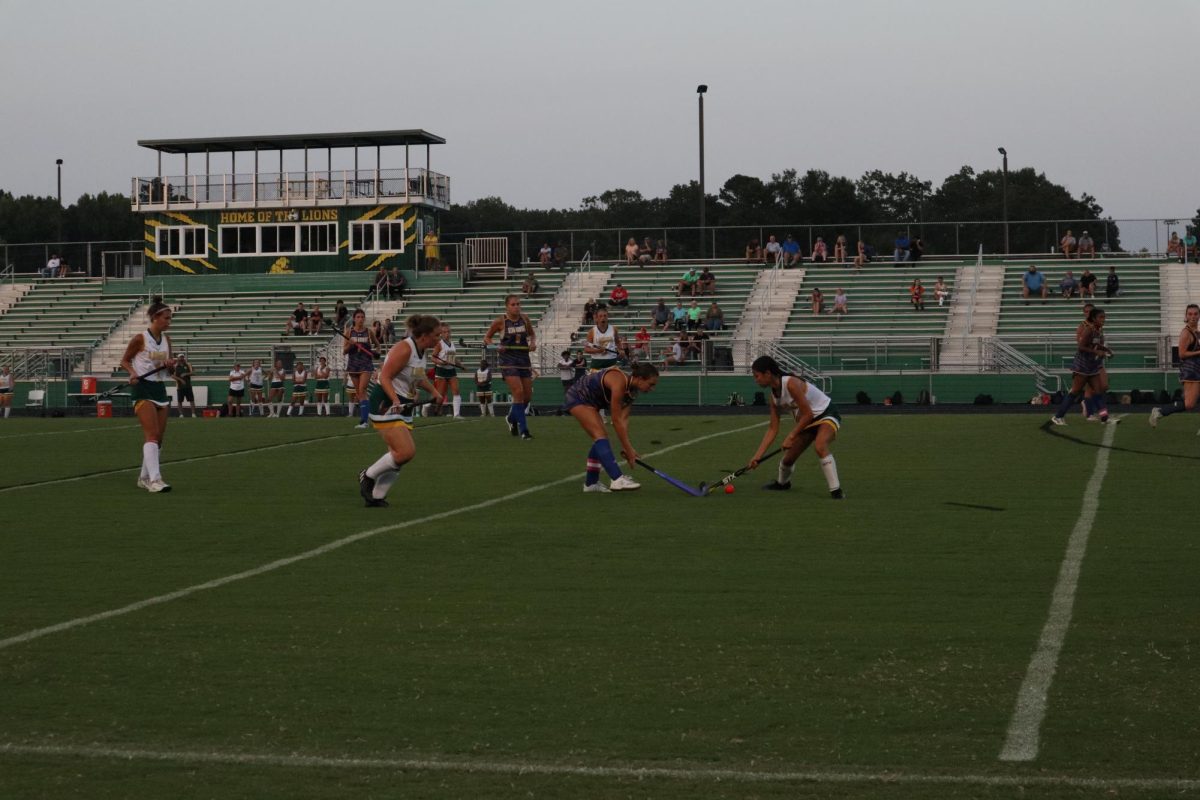 Senior Nyah Straley battles a King George athlete for the field hockey ball.