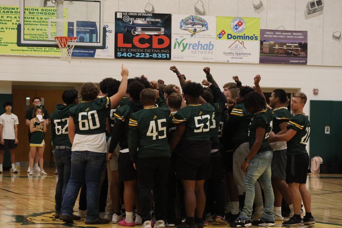 Football coach Willam Patrick rallies the varsity team to prepare for the first home game against Massaponax High School.