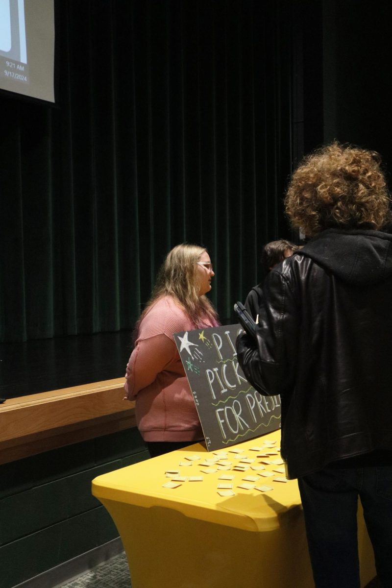 Aubree Pickett talks to fellow classmates about her running for class president