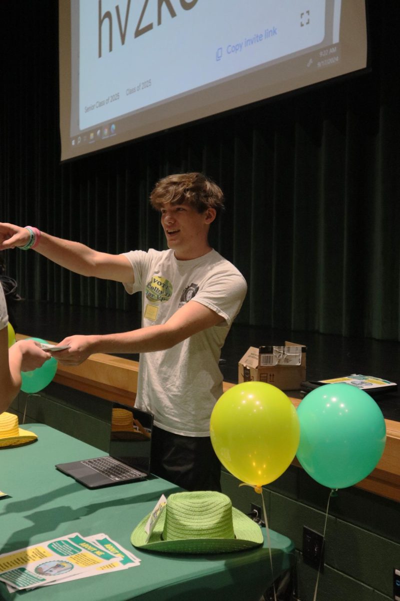 Colby Davis eagerly hands out his campaign merchandise to fellow classmates