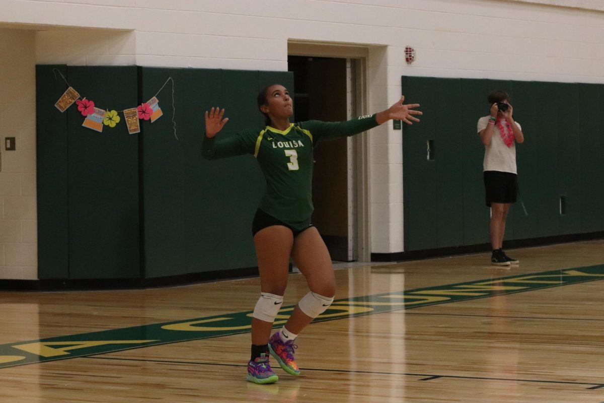 Sophomore Jordan Hope about to serve the ball over the net.