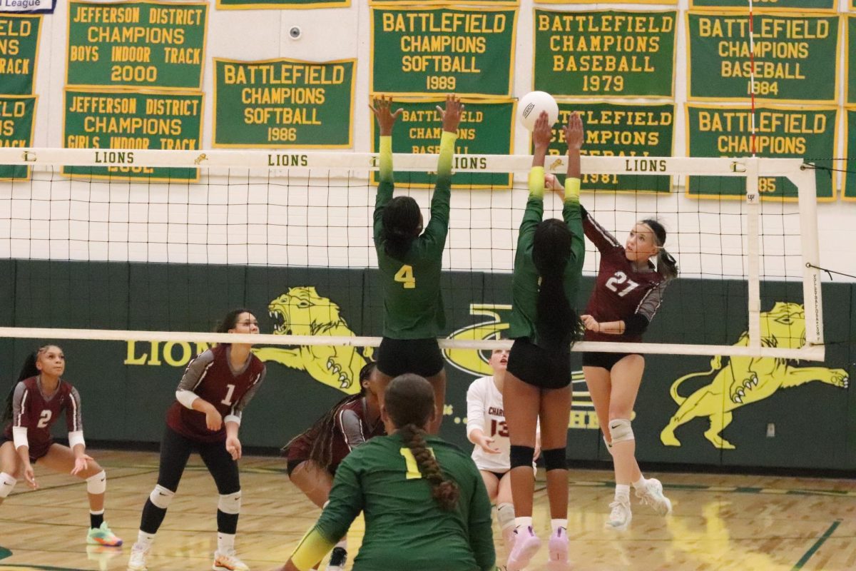 Sophomore duo Makayla Vest-Sims and Isabella williams blocks the ball being spiked by their opponents.