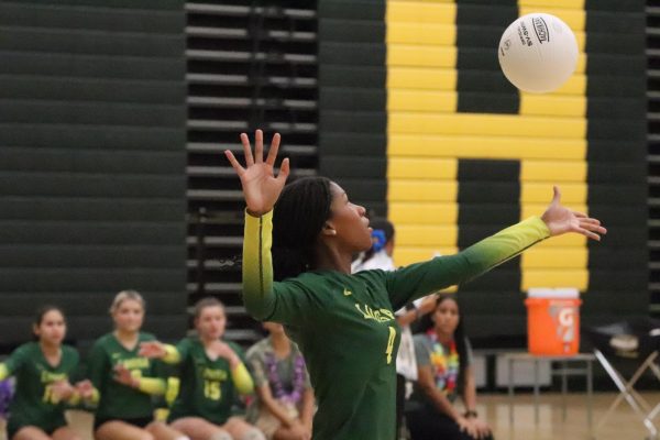 Junior Isabella William is serving the ball to the other team.