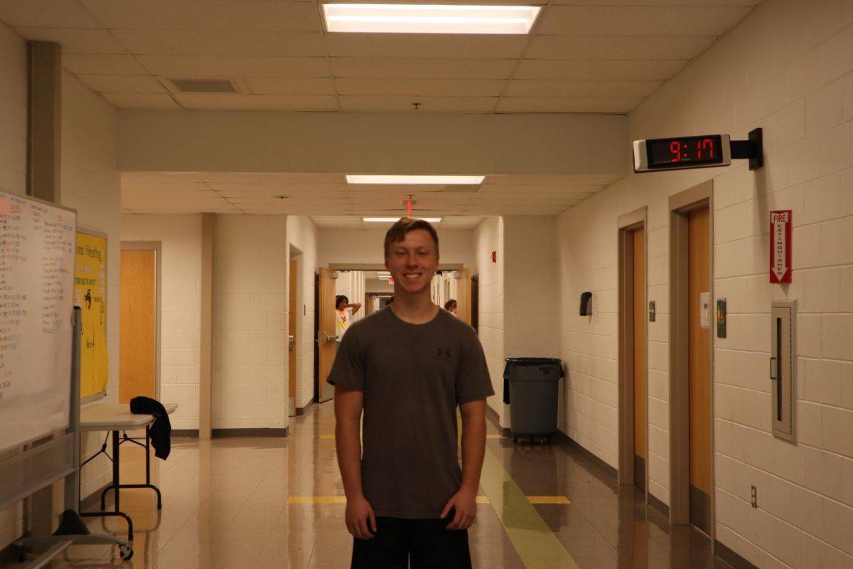 Senior Isaiah Pelloni poses by the gym after sharing why he started floor hockey club.