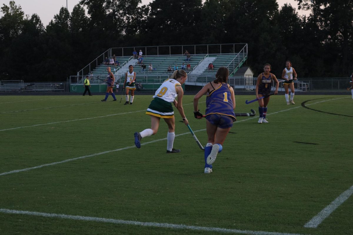 Right forward, Karleigh Lundy, tries to take possession of the ball before the King George athlete does.