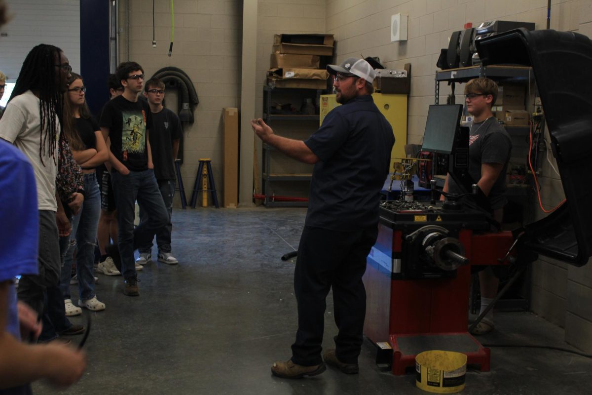 Mr.Galanti teaching his students how to use the wheel balancer.  