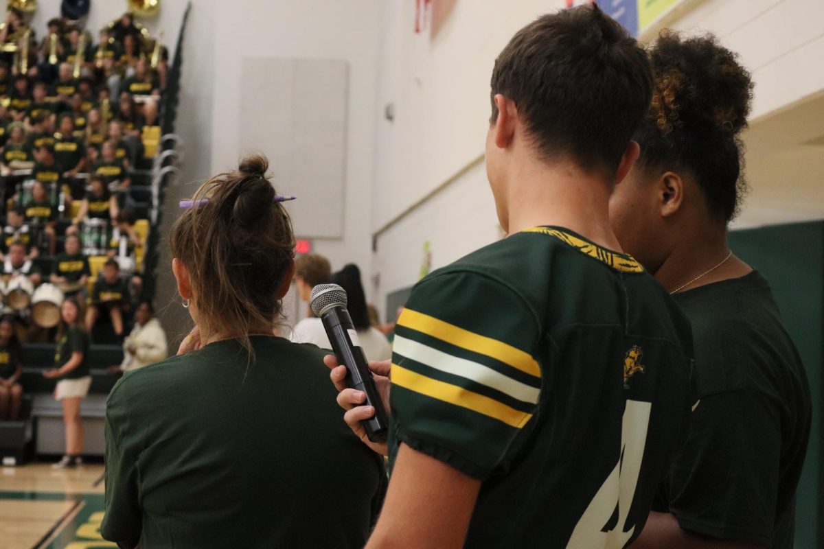 Leadership students Luke Rowan and Amara Comfort discuss before the pep rally begins.