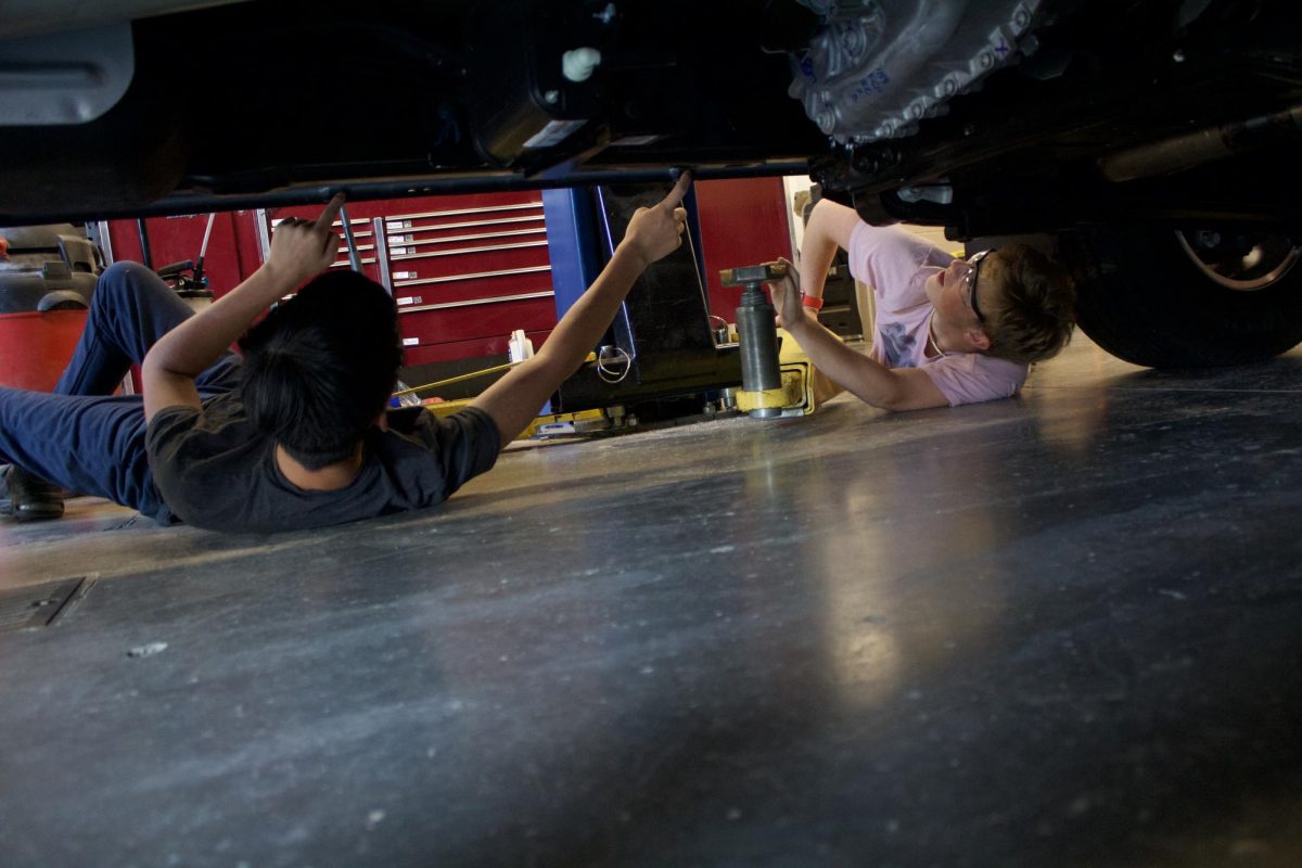 Auto 2 students set the rack so they will be able to lift the car.