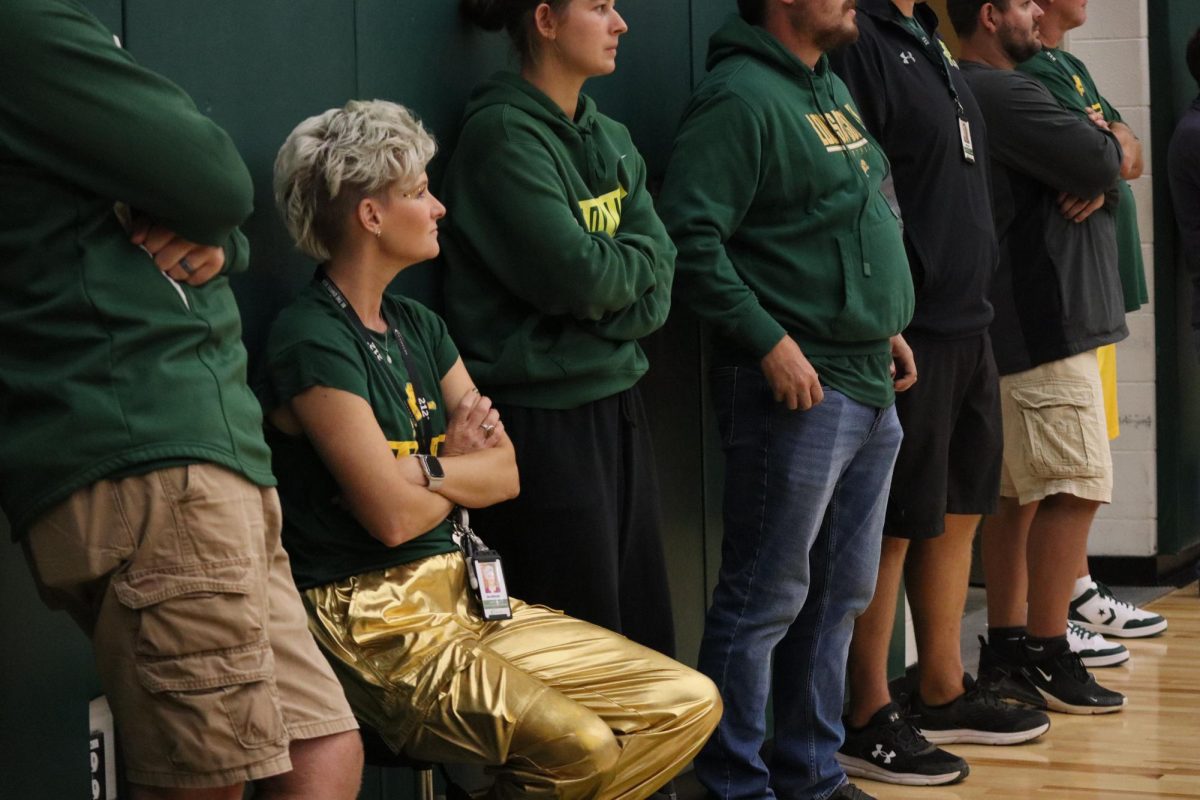 Athletic trainer Sara Whiteside, watches the pep rally games from the side of the gym in curiosity.