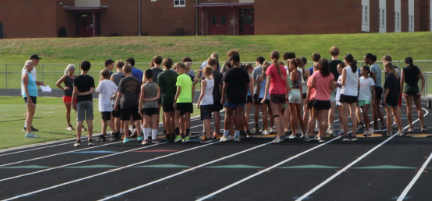 Middle and high school cross country athletes preparing for their track workouts after school on August 29th.