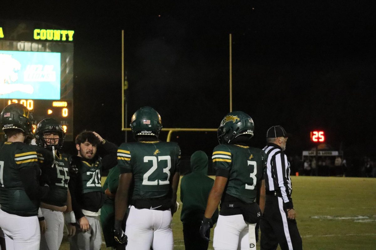 The team huddles together in between plays before they head back out on the field.