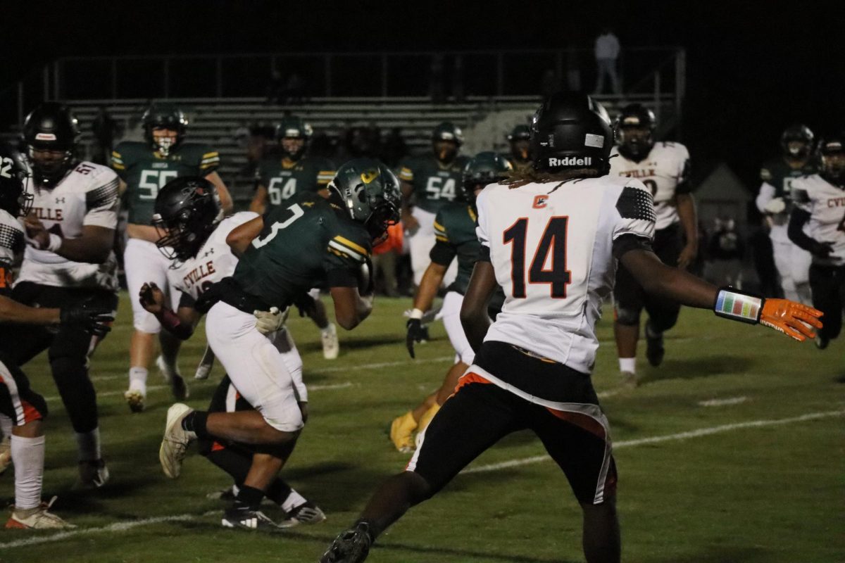 Sophomore Dustin Nelson makes a running play against Charlottesville. 