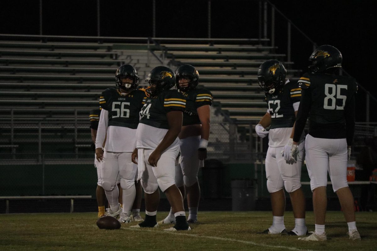 The team goes over plays in order to get ready for the game. 