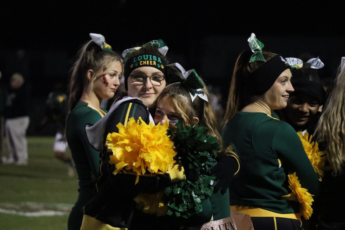 Junior Natalie Spencer and Senior Riley Leale hug each other to keep warm before the game starts. 