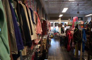 Looking down the rows of Flower Child Consignment, and noticing the variety of colors that are offered to young children.