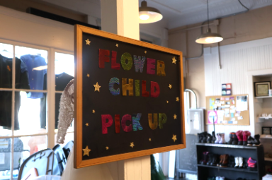 Flower child consignment’s pick up sign, decorated to draw attention to customers.