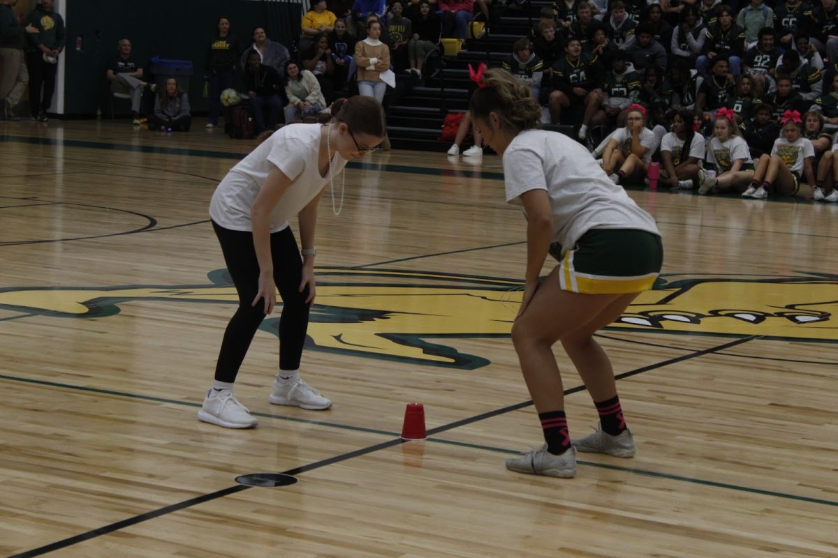 Students go head to head in the “Head, Shoulders, Knees, Cup!” pep rally game.