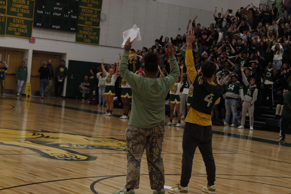 Leadership students Amara Comfort and Luke Rowan lift their hands while directing “Simon Says.”