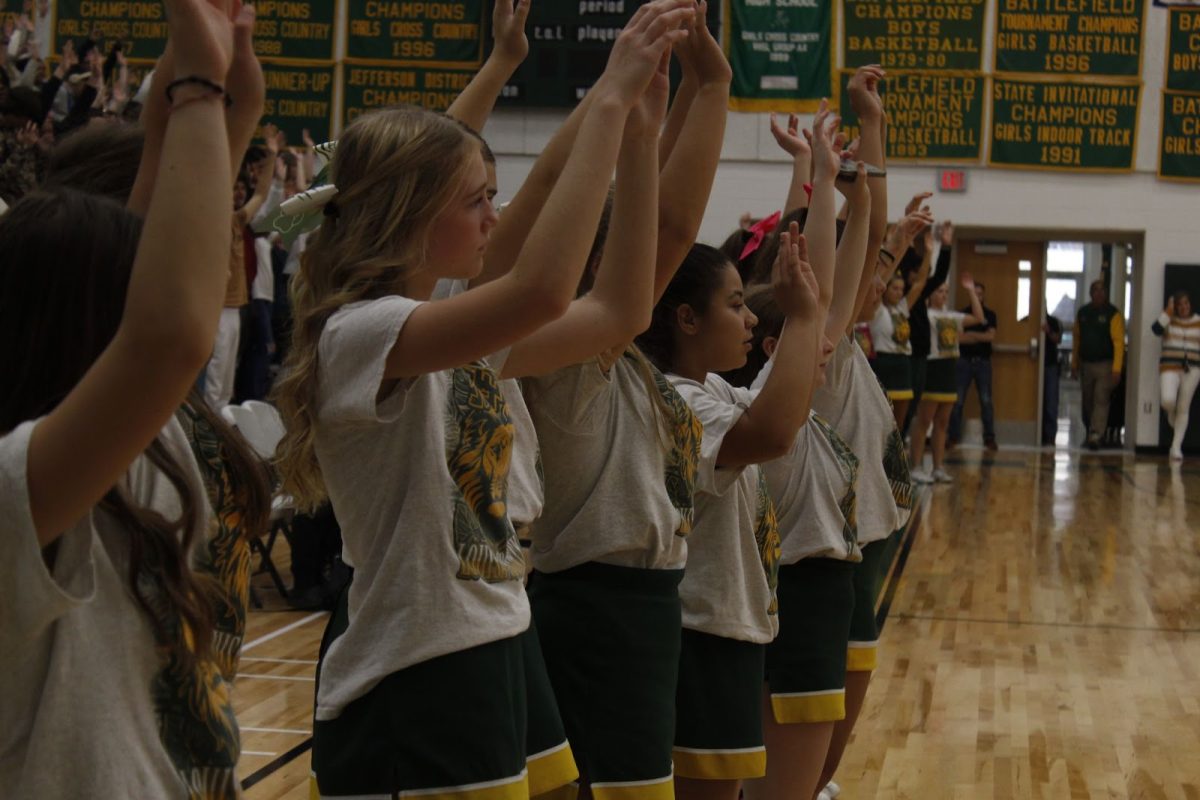 Freshman Cheerleaders play “Simon Says” and raise their hands to stay in the game.