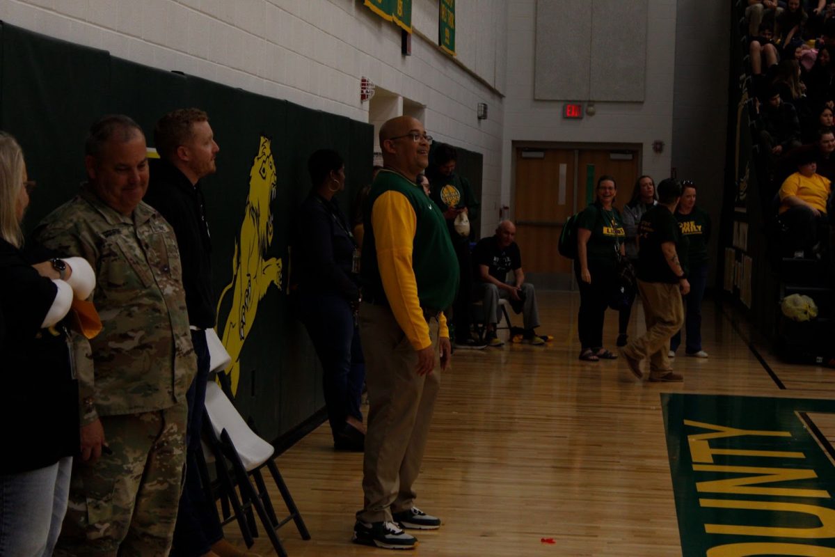 Principal Rodney Redd watches the students playing “Simon Says” with a prideful grin.