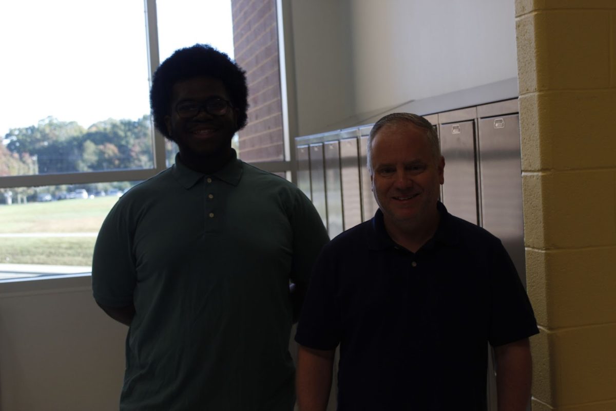 Sophomore Warren Coles (left) and History Teacher Shannon Knight (right) stand side by side with matching polos and jeans for Teacher Swap Spirit Day.
