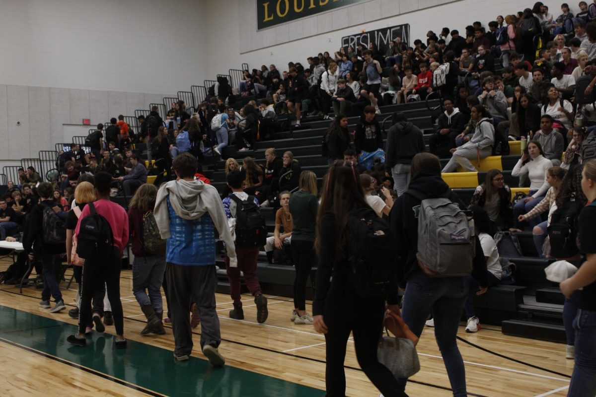 Students enter the pep rally and get seated in their grade-level sections.
