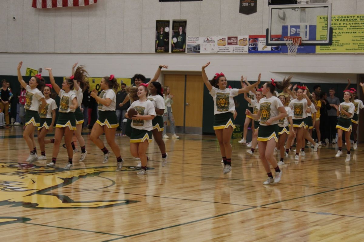 Competition Cheerleaders make their entrance into the pep rally showing excitement for the up-and-coming game.