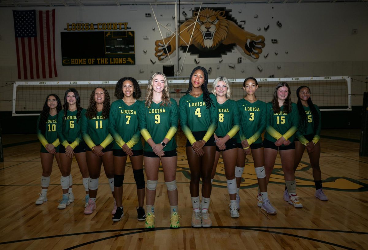 The Varsity Volleyball team posing for a team picture in The Den courtesy of Haley Rosson