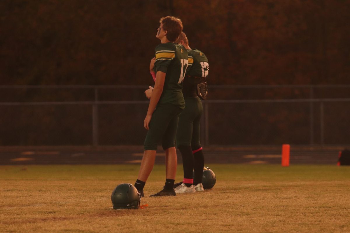 Connor Morris and player standing for the national anthem before the game