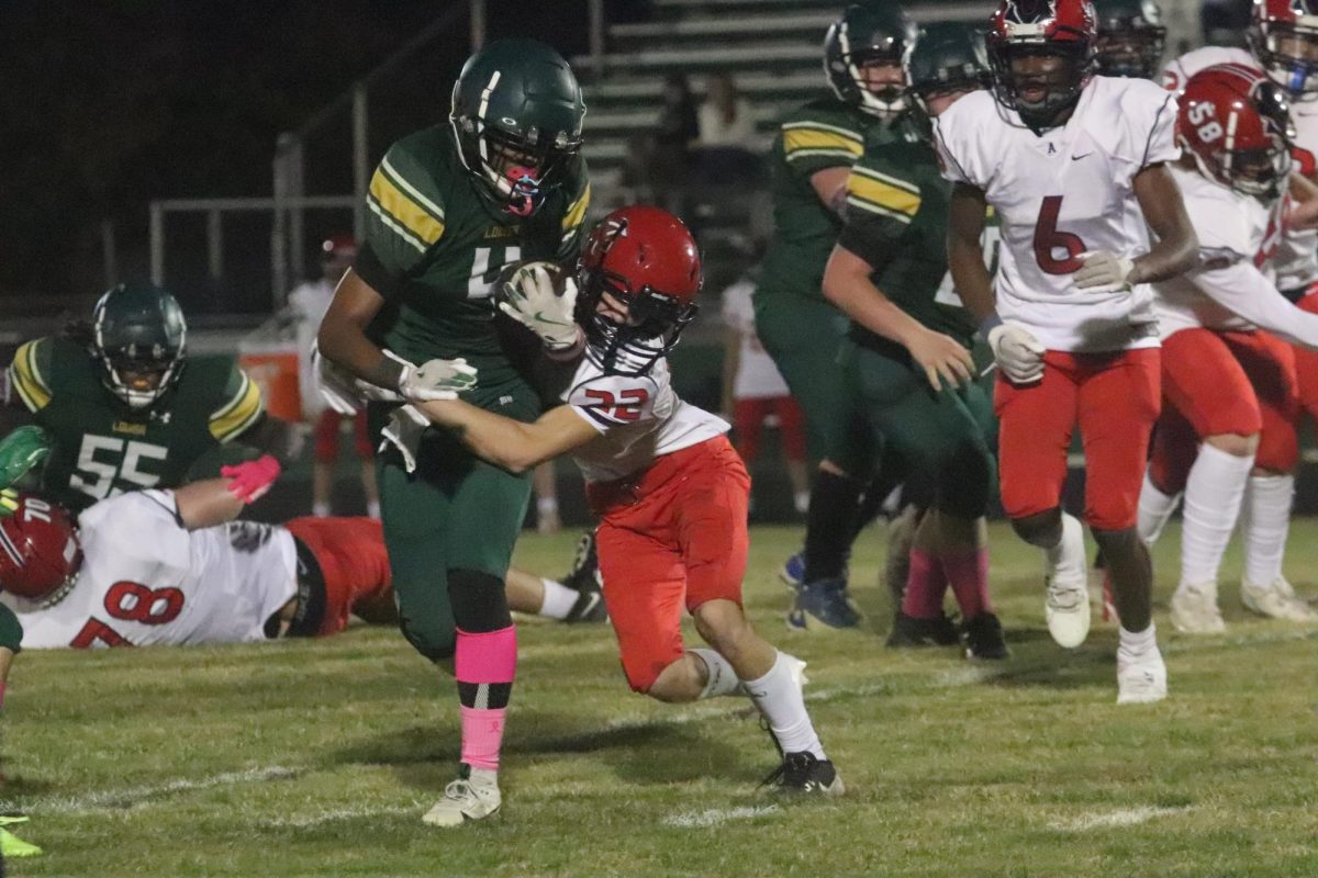 Running Back King Barbour breaking a tackle while running down the field toward the end zone.