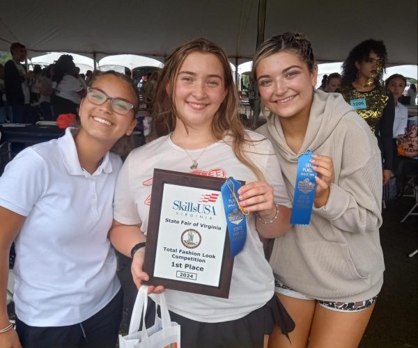 Juniors Chloe Cajigas, Vanessa Breslin, and Charlee Davis pose with their first place award they won in the total look competition at the State Fair.