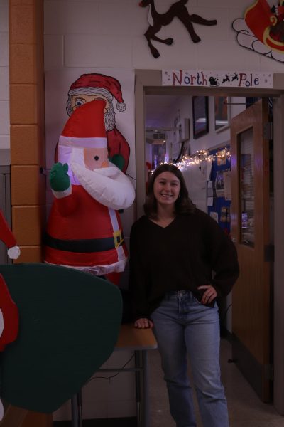 Gabriella McGehee smiles as she poses next to Santa Claus.