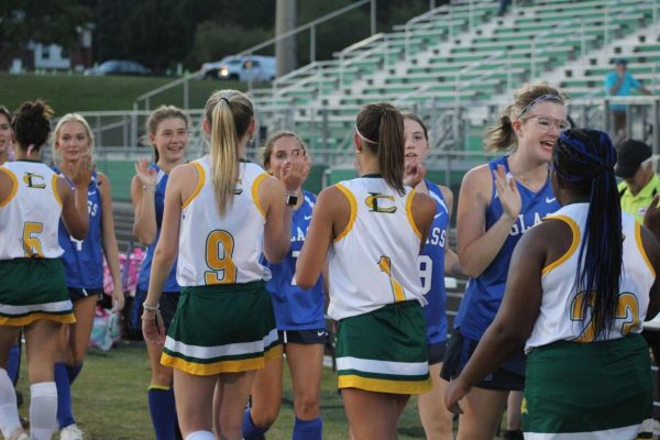 The team high fives the opposing players of E.C Glass High School after a 6-0 win for the lions. Courtesy of Madison Stewart.