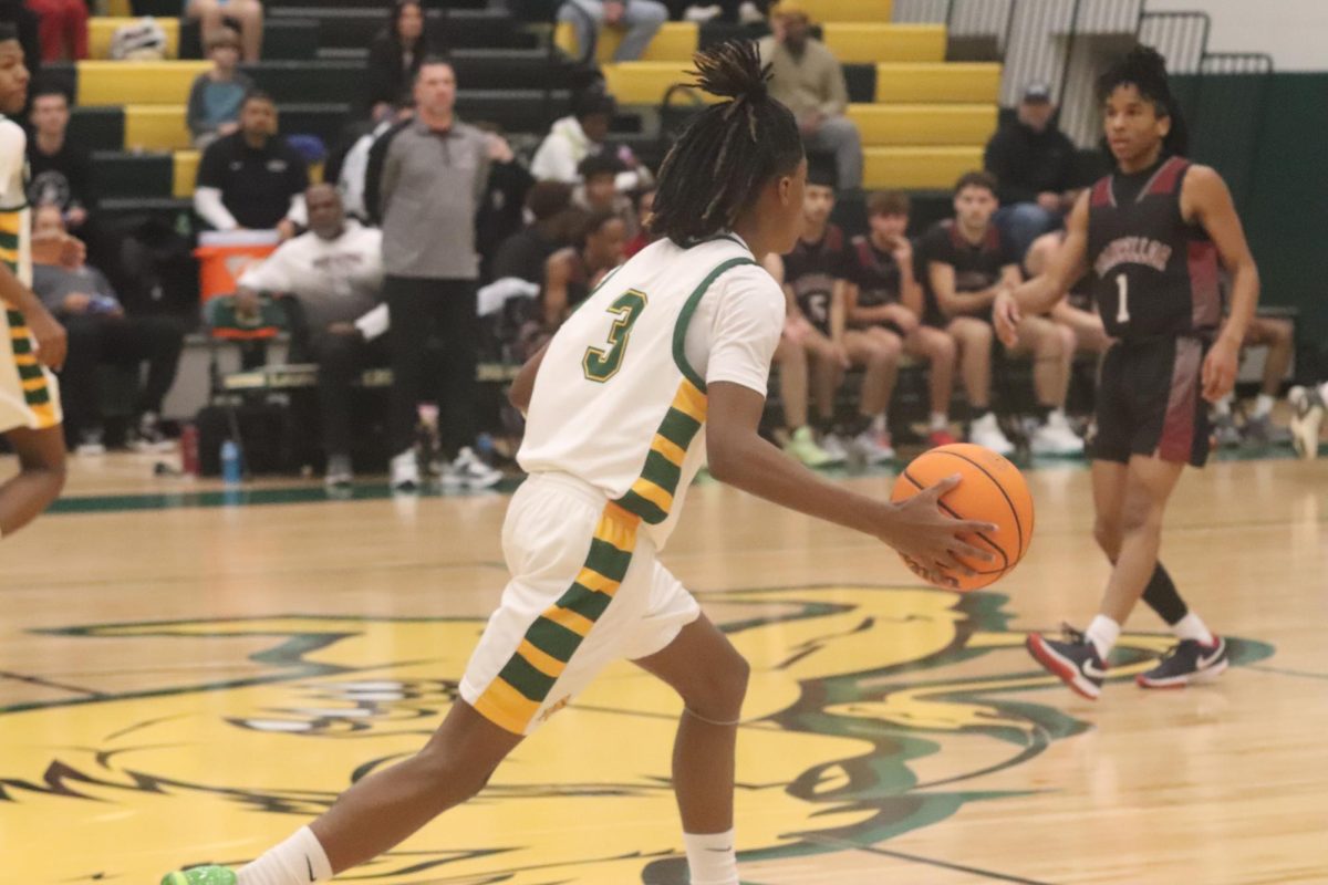 Guard Johaun Ellis dribbles the ball across half-court to start the offense.