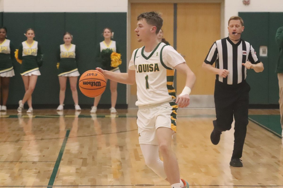 Senior gaurd Patrick Moore starts up the offense brings the ball up the court.