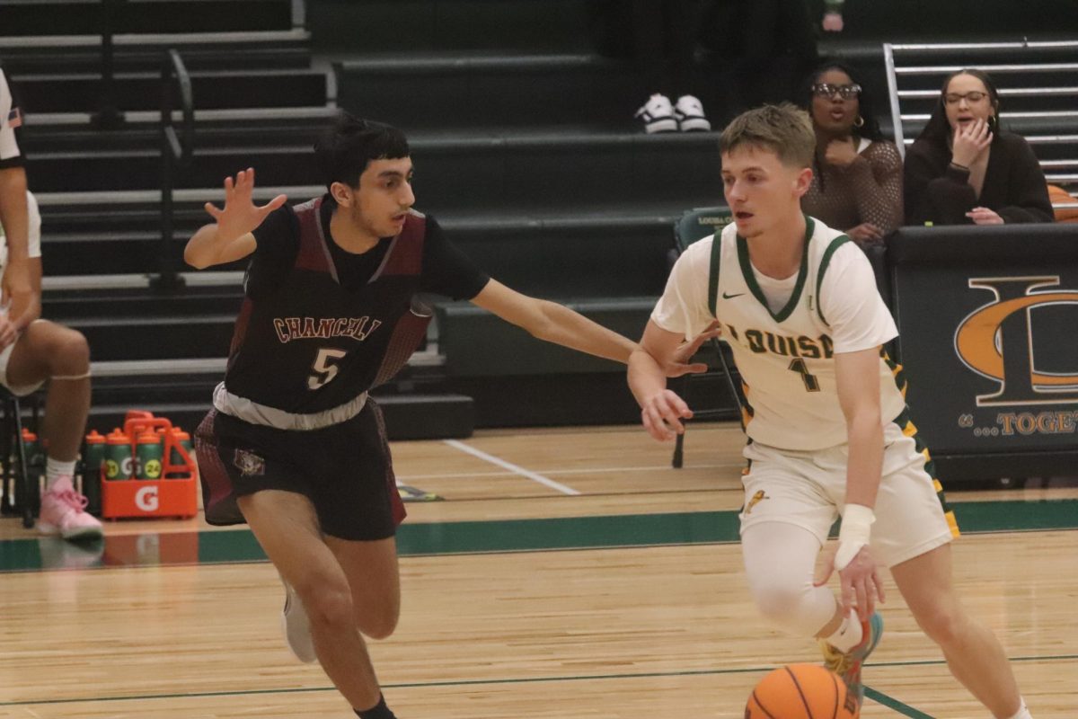 Senior Guard Patrick Moore tries to dribble past his defender to get down hill.