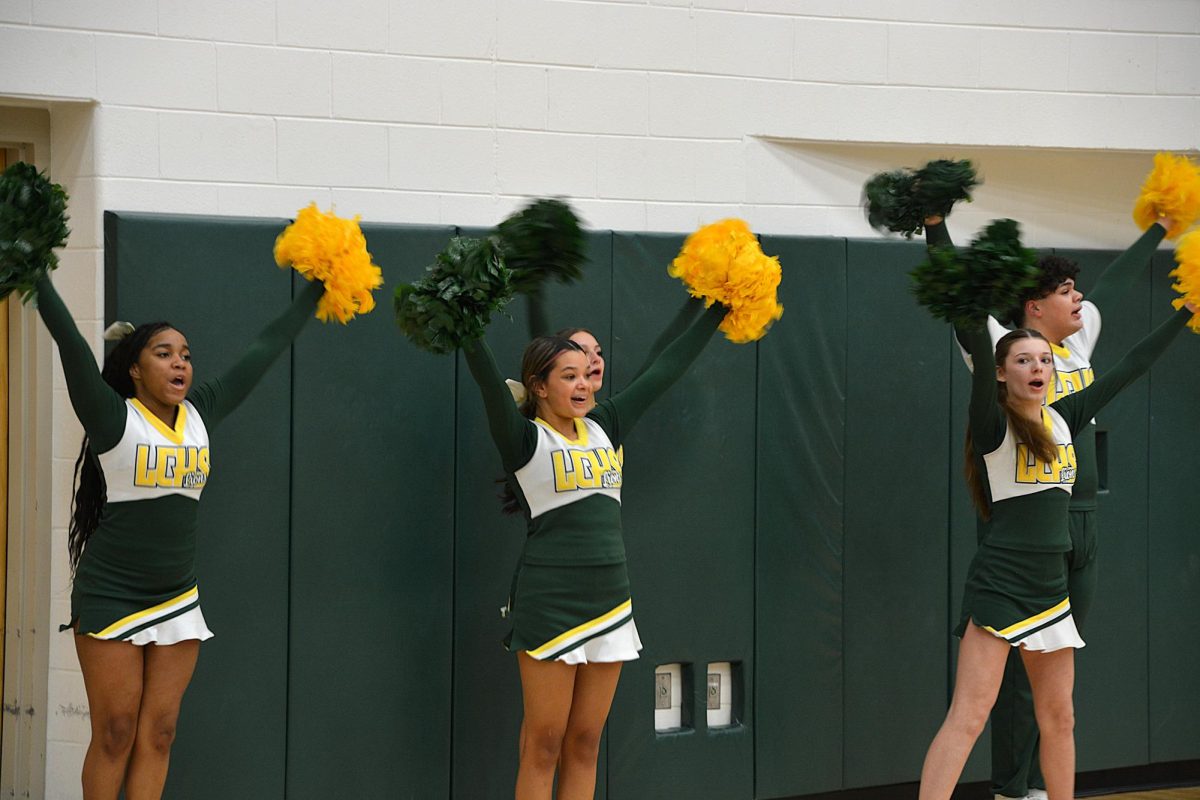 Varsity Lions cheerleaders encourage the team going into halftime.
