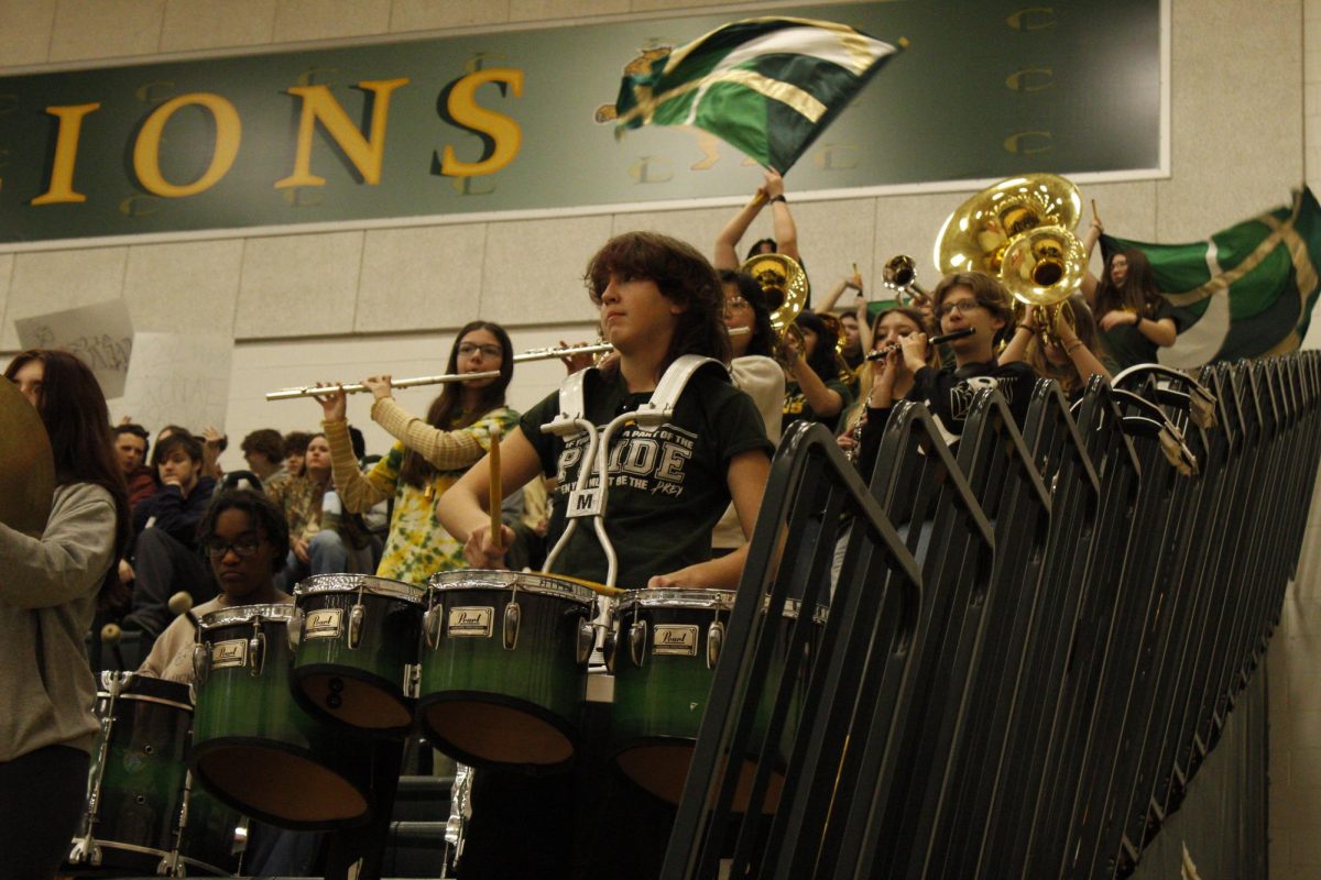 Lion Pride Marching Band plays during a time out for Louisa.
