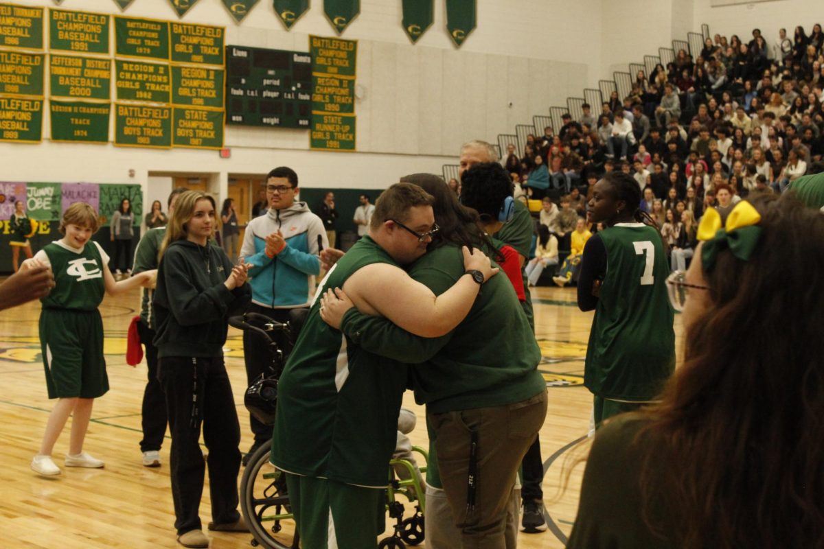 Talley hugs his teacher Ms. Pullen before the game.