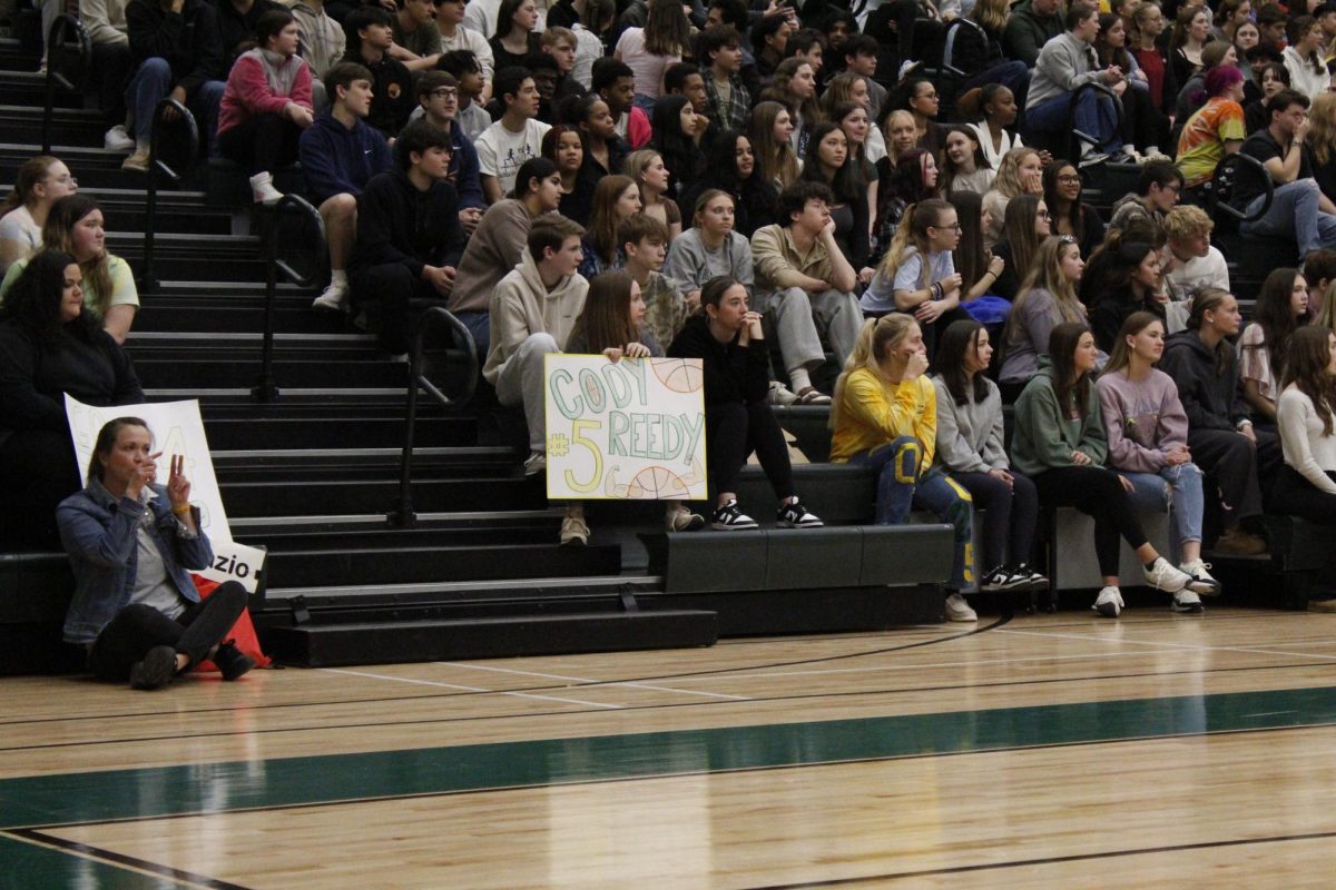 Kourtney Kidd and Alyssa Hopkins cheer for team member Cody Reed.
