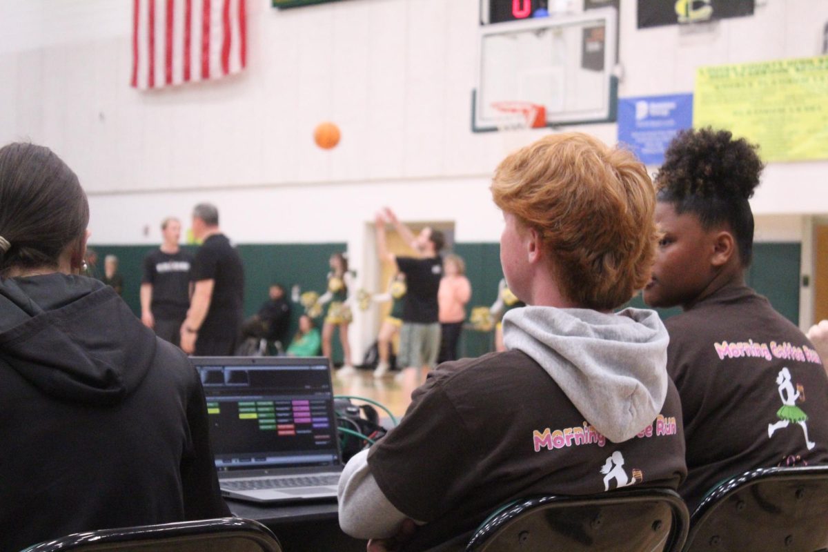 Leadership members help out with music and organization during the Senior vs. Faculty basketball game.
