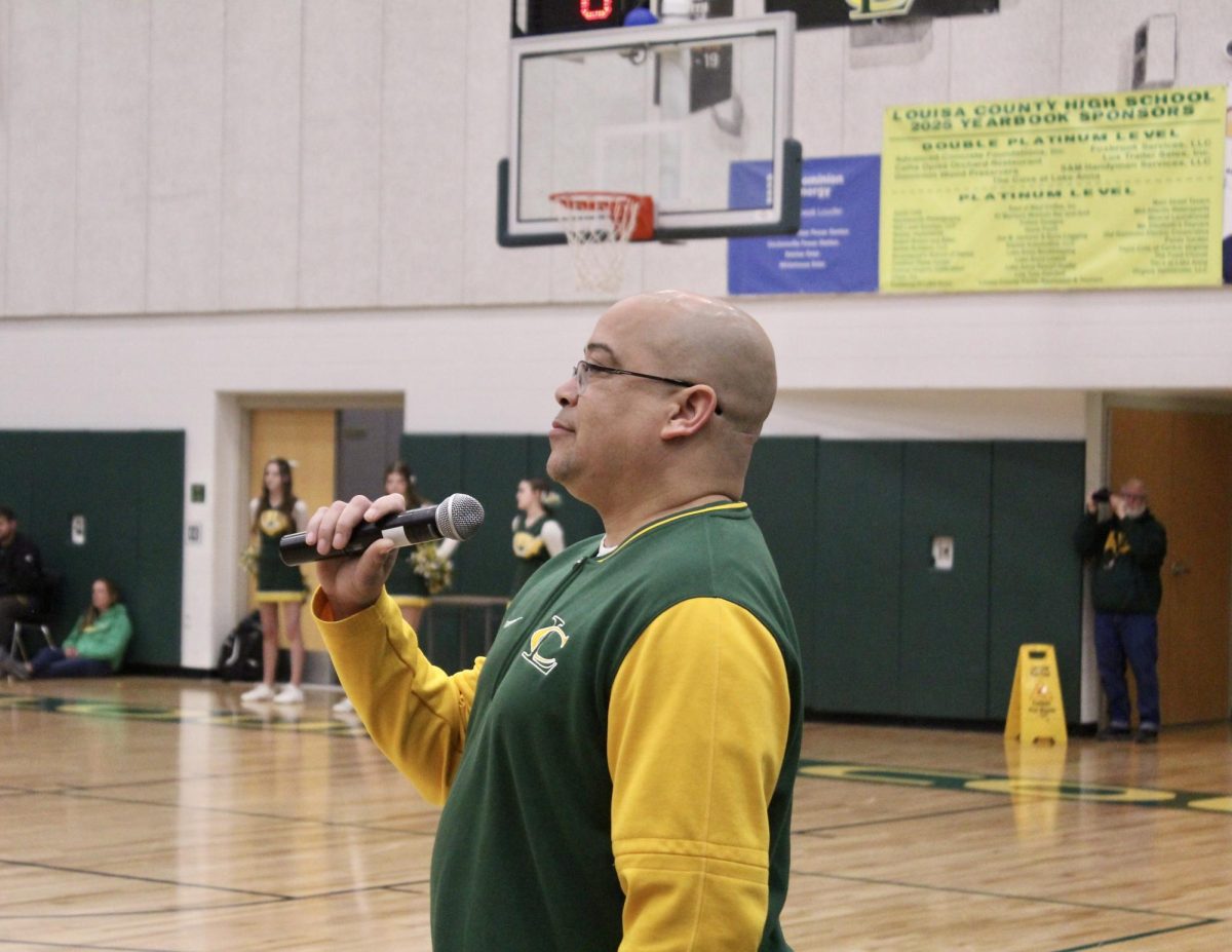 Principal Redd speaks to all the students at the pep rally before the start of activities. 