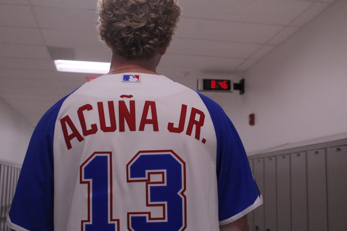 Junior Brady Walton showing the back of his Ronald Acuna Jr.  jersey.