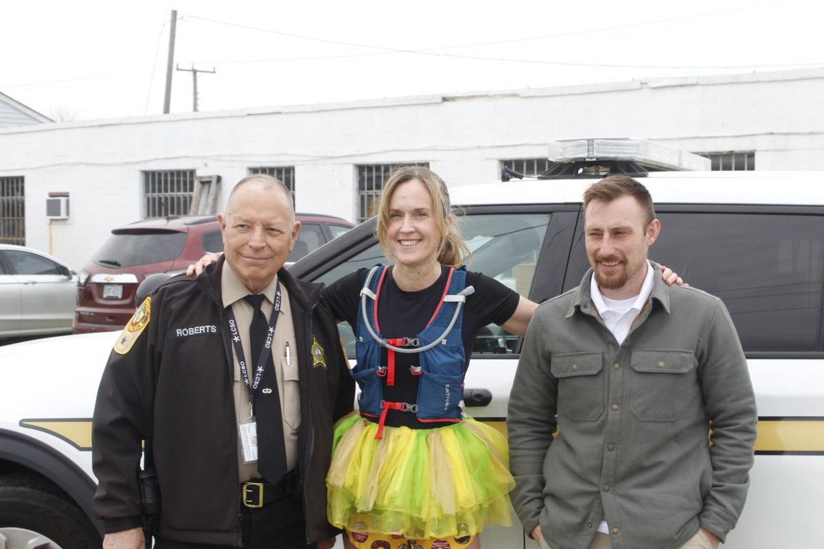 Officer Roberts and Detective Shreve pose for a photo after being a police escort for Fletcher throughout her run.