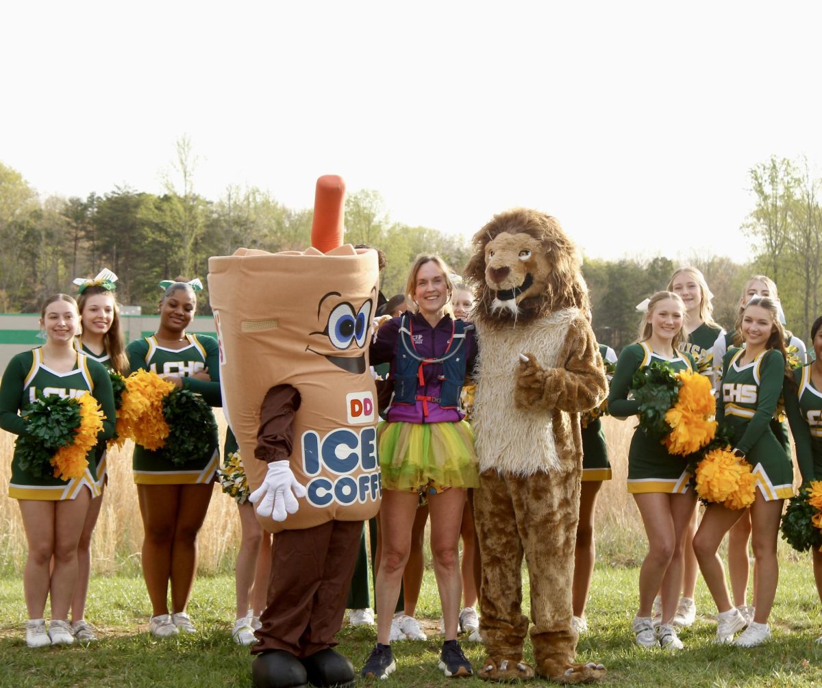 After arriving at Dunkin, Fletcher is accompanied by the cheer team and mascots.
